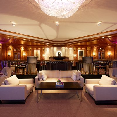 Elegant lounge with comfortable sofas, wooden walls, and soft lighting